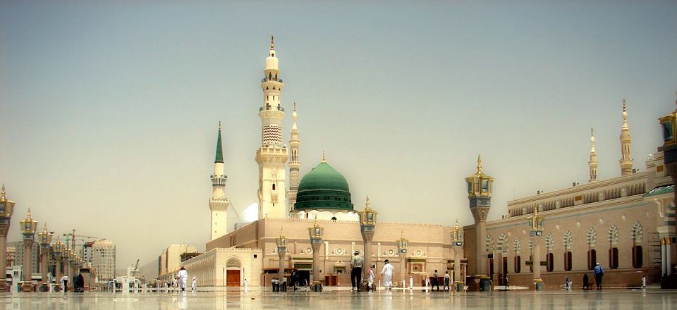 When the Prophet migrated to Medina, how did he create religious coexistence?